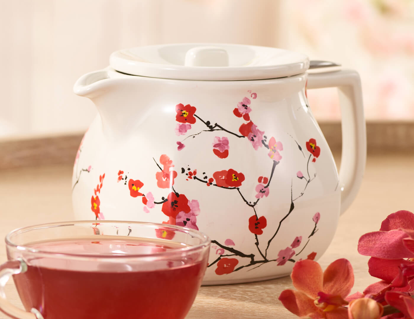 Fiore Sakura Teapot with lid on table with glass cup of tea